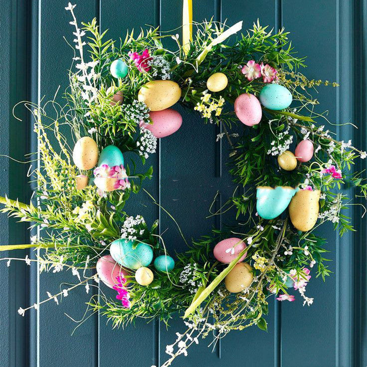 Decorative Easter wreath with colorful eggs and flowers on a blue door.