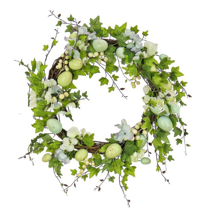 Decorative wreath with green leaves and Easter eggs on a white background