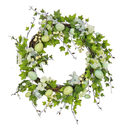Decorative wreath with green leaves and Easter eggs on a white background